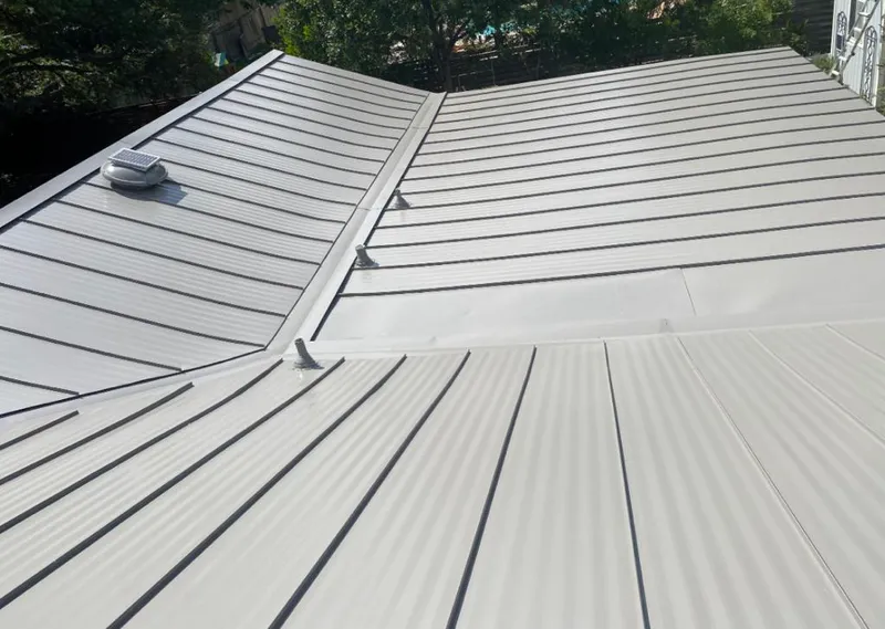 Solar attic fan installed on a metal roof for Roof Ventilation in Milliken